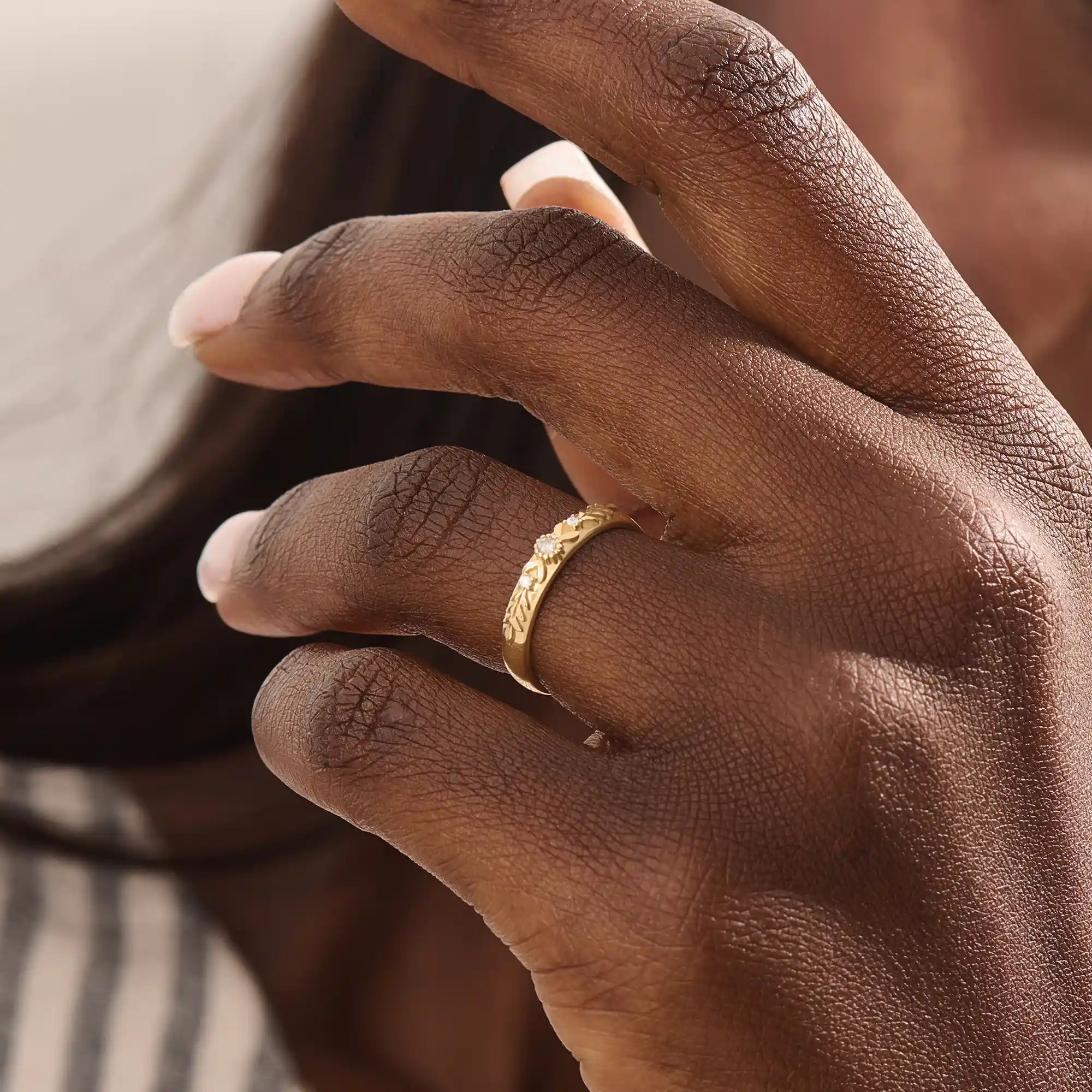 Model wears a vintage design 14k gold leaf band promise ring featuring detailed leaf engravings. Perfect for meaningful everyday wear or gifting.