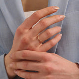 Model wears an ultra thin 14k gold curve ring, perfect for nesting or stacking. A subtle and elegant choice for a refined ring stack.