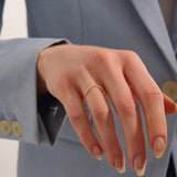 Model wears an ultra thin 14k gold curve ring, perfect for nesting or stacking. A subtle and elegant choice for a refined ring stack.