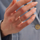 Model wears an ultra thin gold beaded band stacking ring. A subtle and elegant piece ideal for everyday wear and stacking.