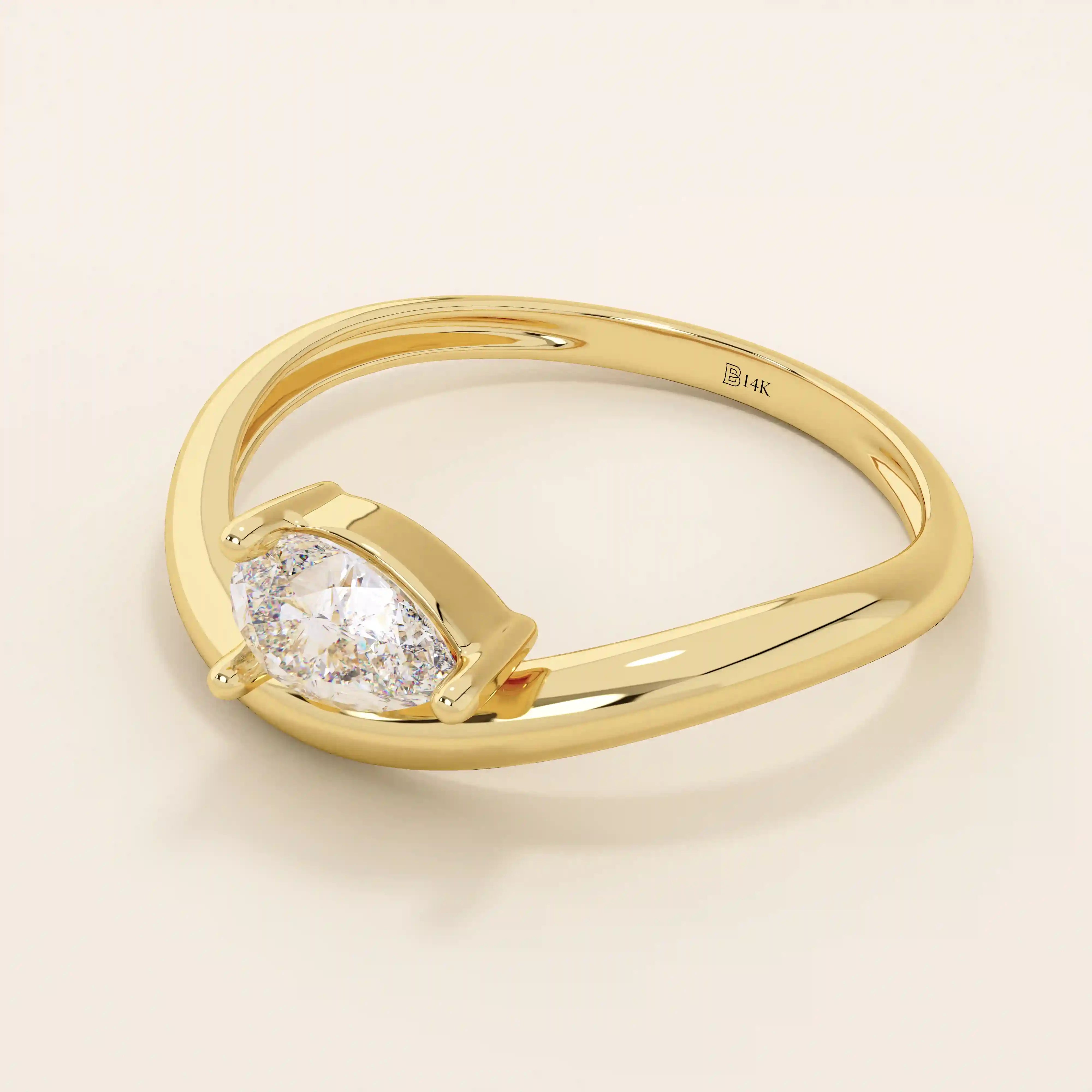 Pear cut moissanite solitaire engagement ring on a curved 14k solid gold band, minimalist design with a modern twist.
