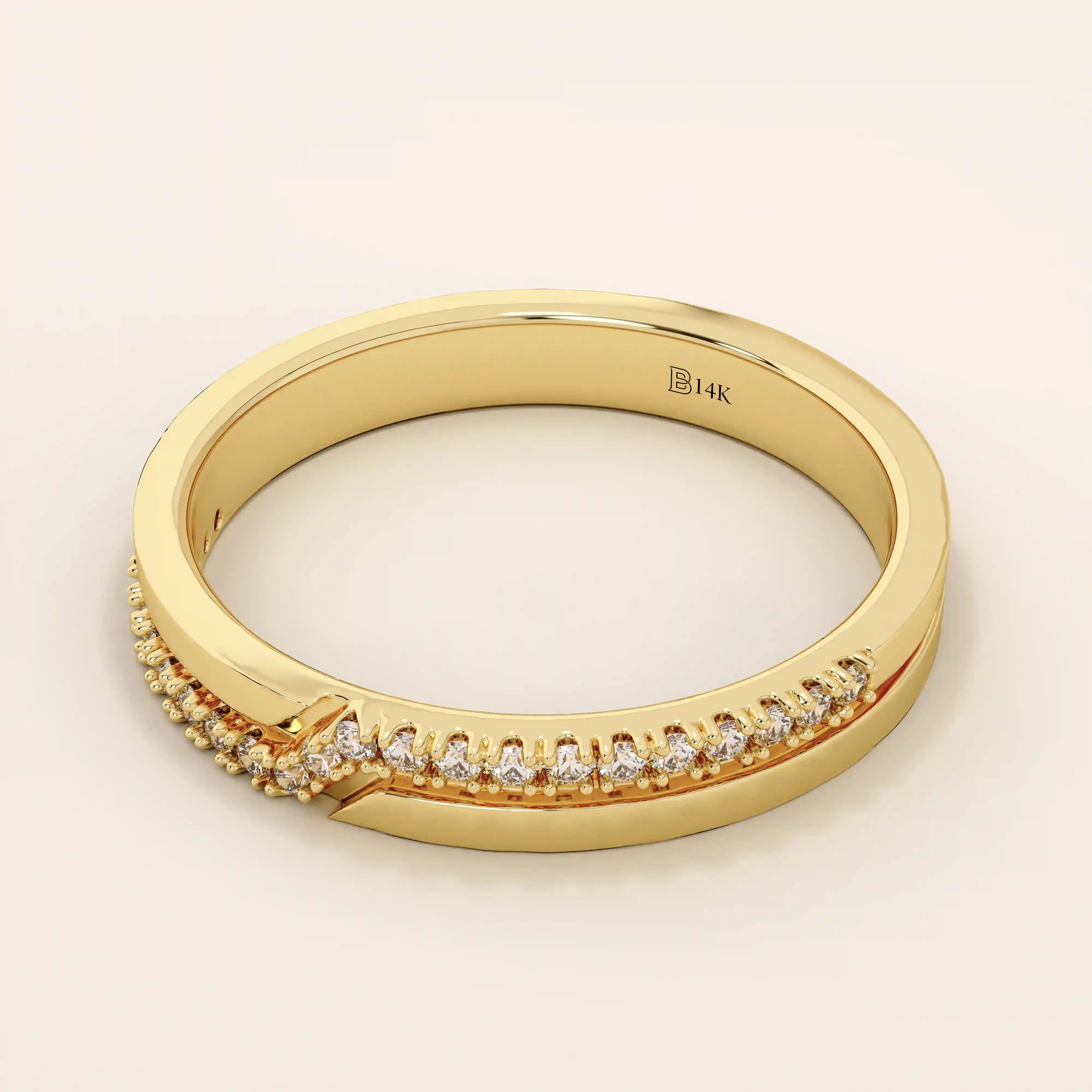 Side angle view of a 14k solid yellow gold band with pointed chevron design and pavé set round brilliant cut moissanite stones, contemporary and refined bridal jewelry