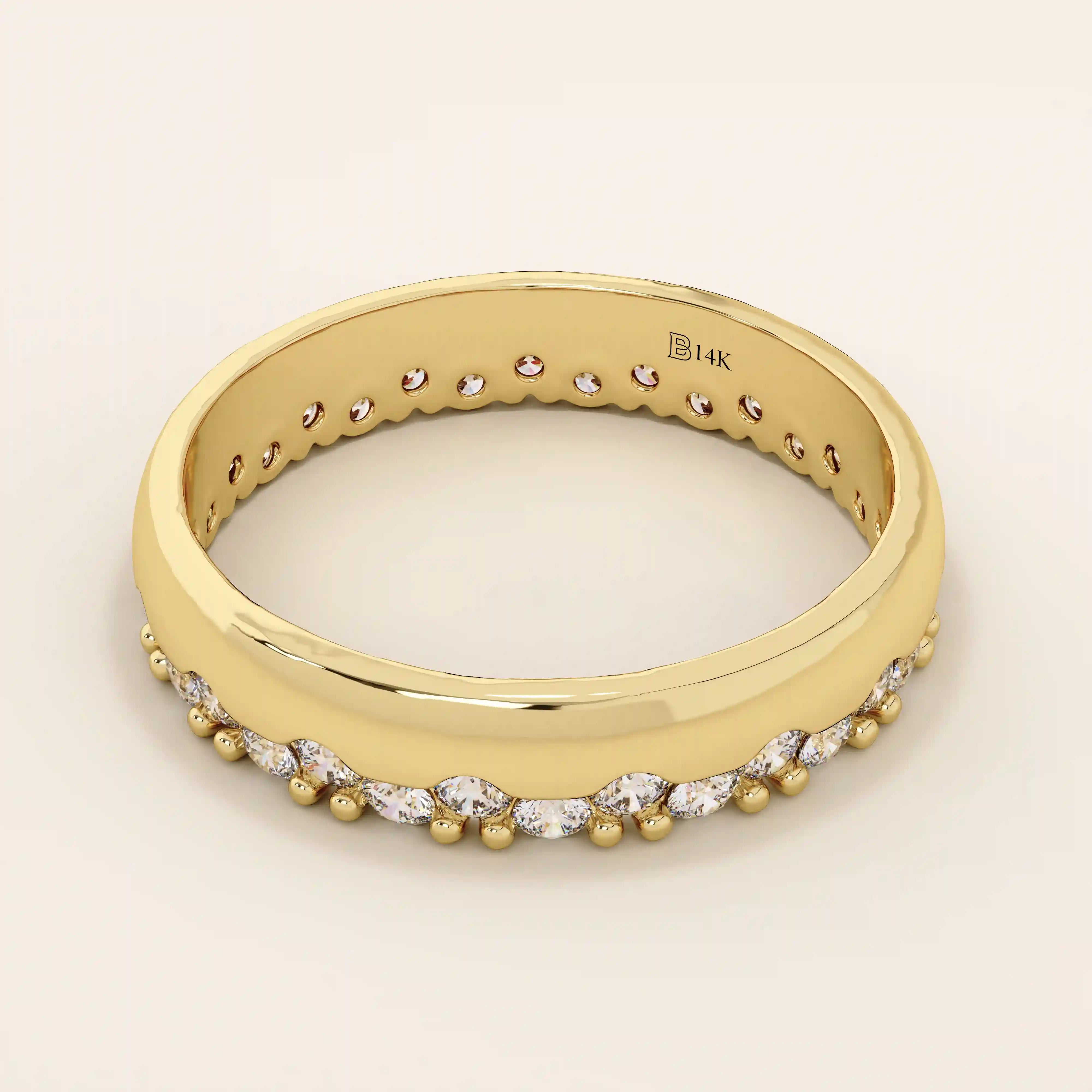 Side angle view of a 14k solid yellow gold band with round brilliant cut moissanite stones in a single row and bead accents, sophisticated and minimal bridal jewelry