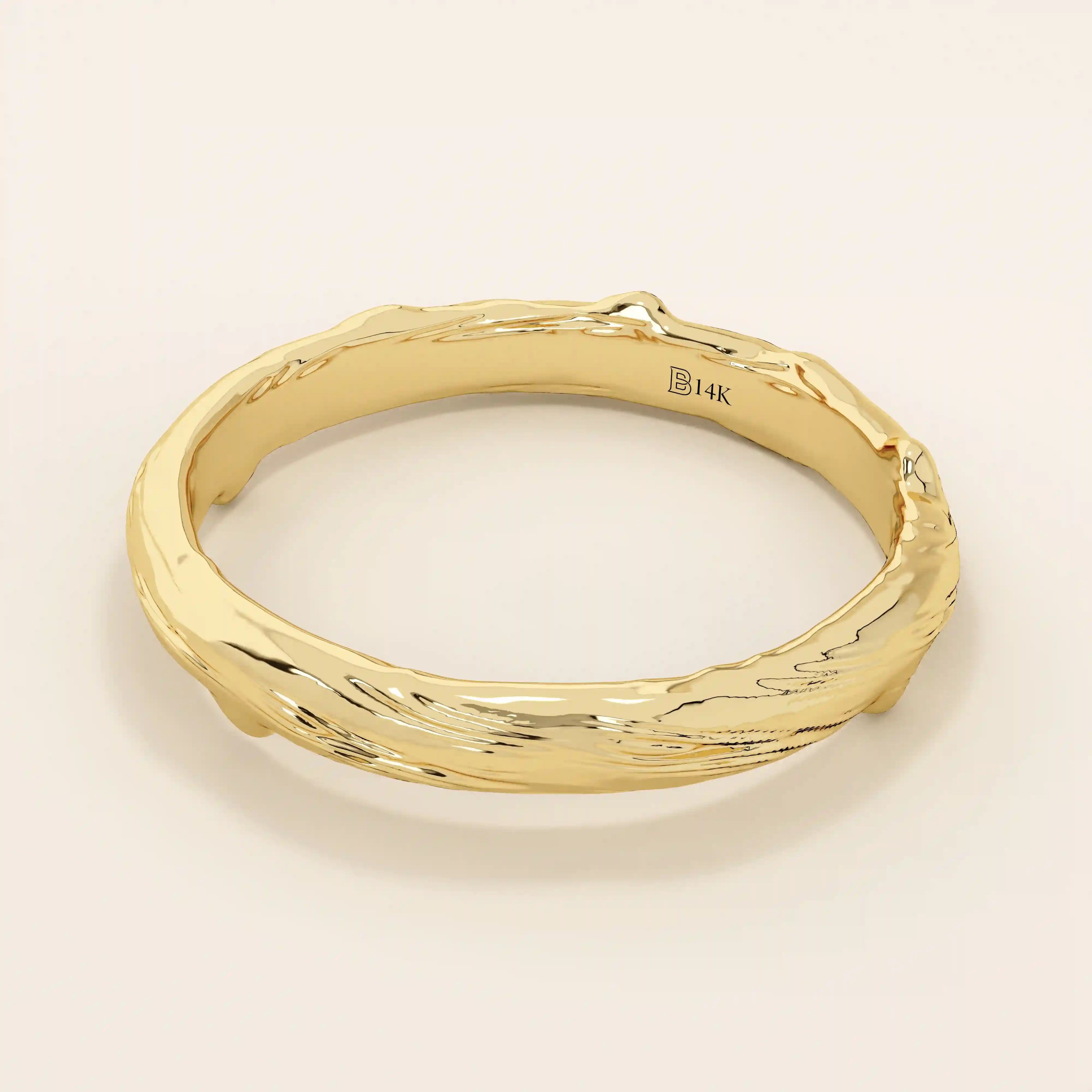 Side angle view of a 14k solid yellow gold wedding band with woodgrain-inspired detailing, nature-inspired craftsmanship