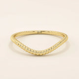 Slim curved stacking ring in 14k solid gold with a delicate twisted band. Designed to nest with engagement rings or wear alone for subtle texture.