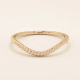 Slim curved stacking ring in 14k solid gold with a delicate twisted band. Designed to nest with engagement rings or wear alone for subtle texture.