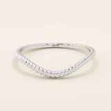 Slim curved stacking ring in 14k solid gold with a delicate twisted band. Designed to nest with engagement rings or wear alone for subtle texture.