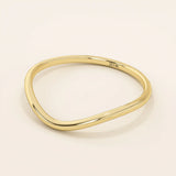 Ultra slim curved nesting ring in 14k solid gold, designed for a seamless fit around engagement rings. Minimalist and lightweight for everyday wear.