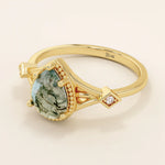 Vintage-inspired 14k gold ring featuring a pear cut natural moss agate. Unique gemstone anniversary ring with organic patterns.