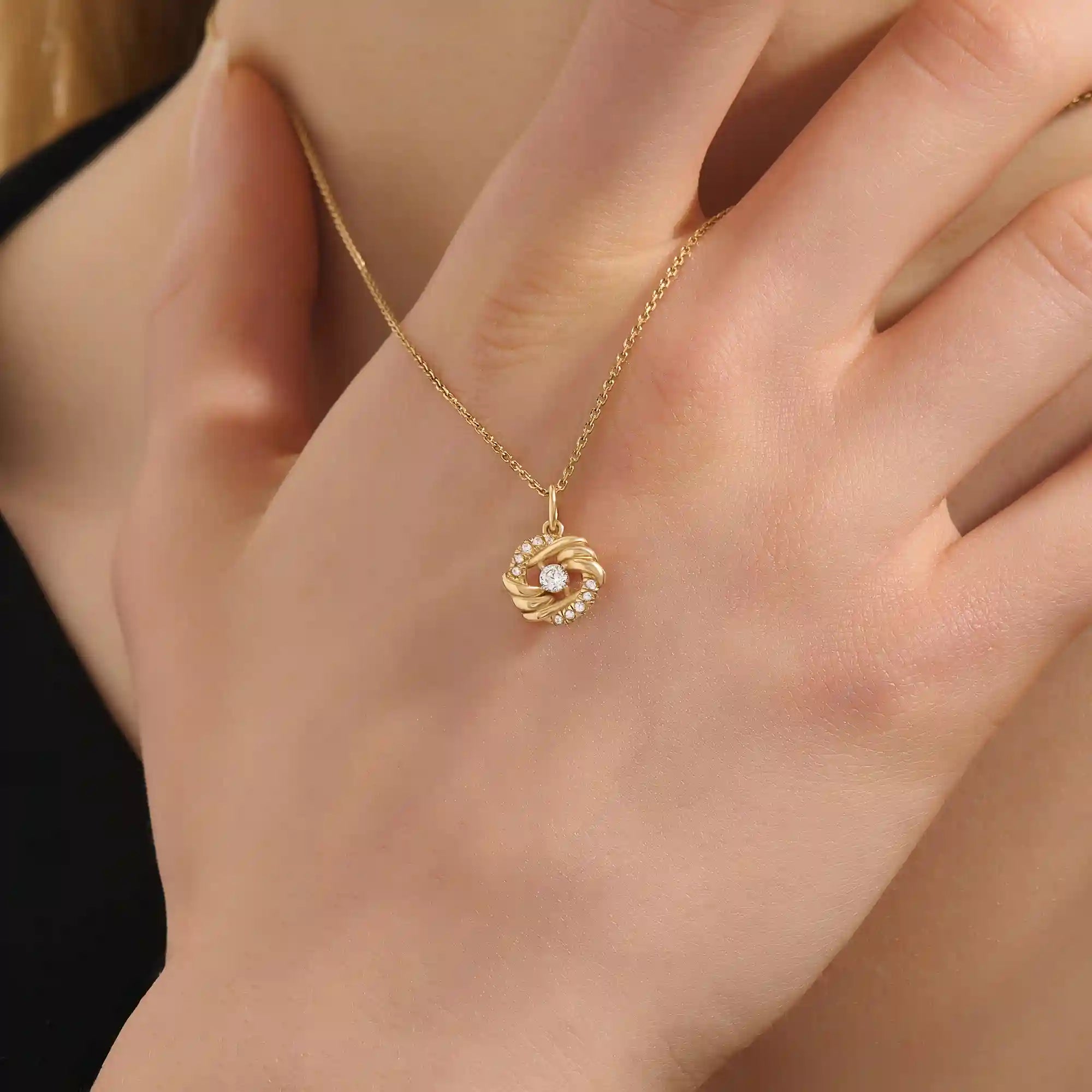 Woman wearing a 14k solid gold circle pendant necklace with sparkling pave moissanites. Unique and stylish gold jewelry piece. Perfect for everyday elegance or layering.