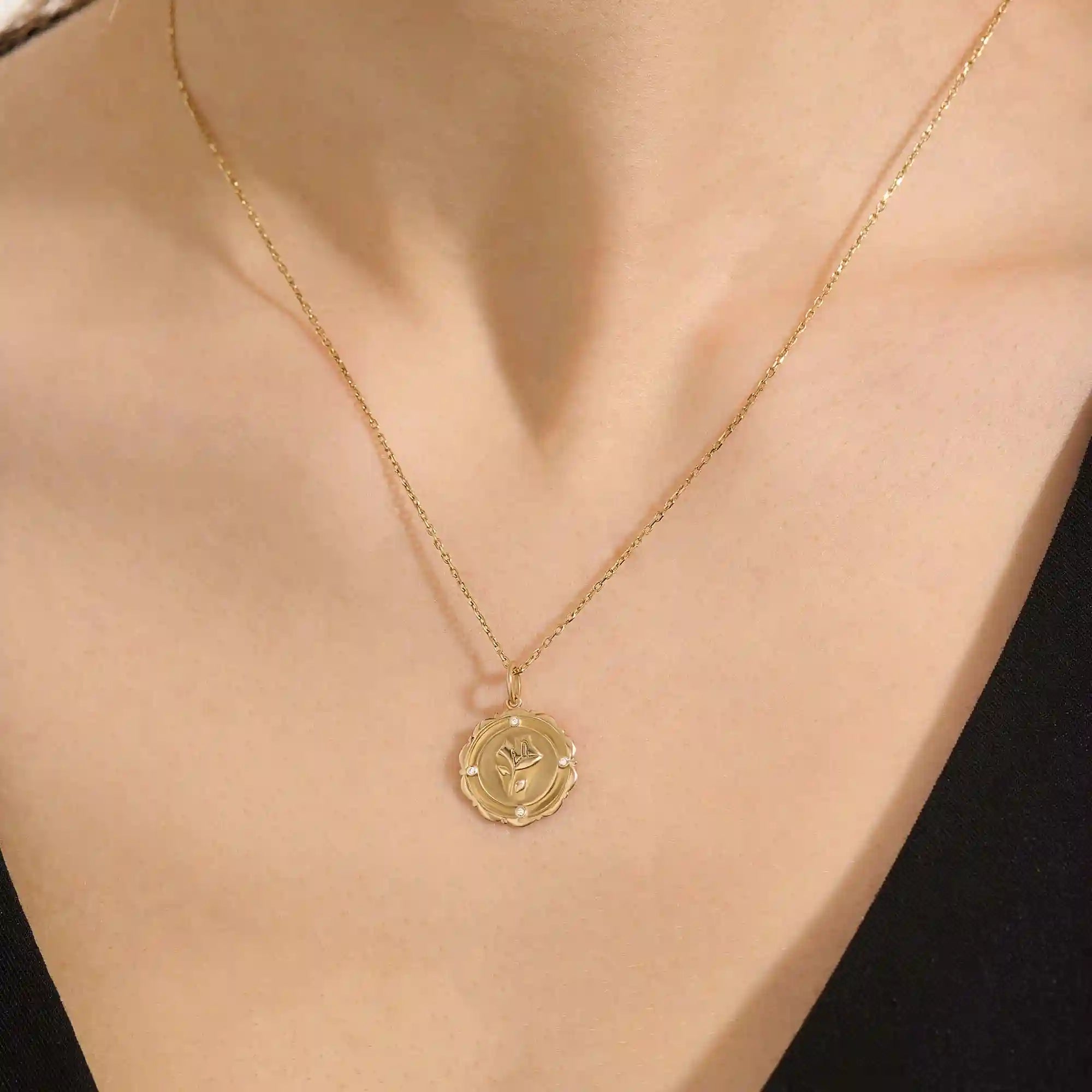 Woman wearing a 14k solid gold rose pendant necklace with delicate moissanite details. Floral-inspired minimalist jewelry styled for everyday. A timeless gold necklace for women.