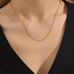 Woman wearing a 14k solid gold textured chain necklace with a soft shimmer. Stylish and easy-to-wear gold chain for daily looks. Perfect on its own or layered.