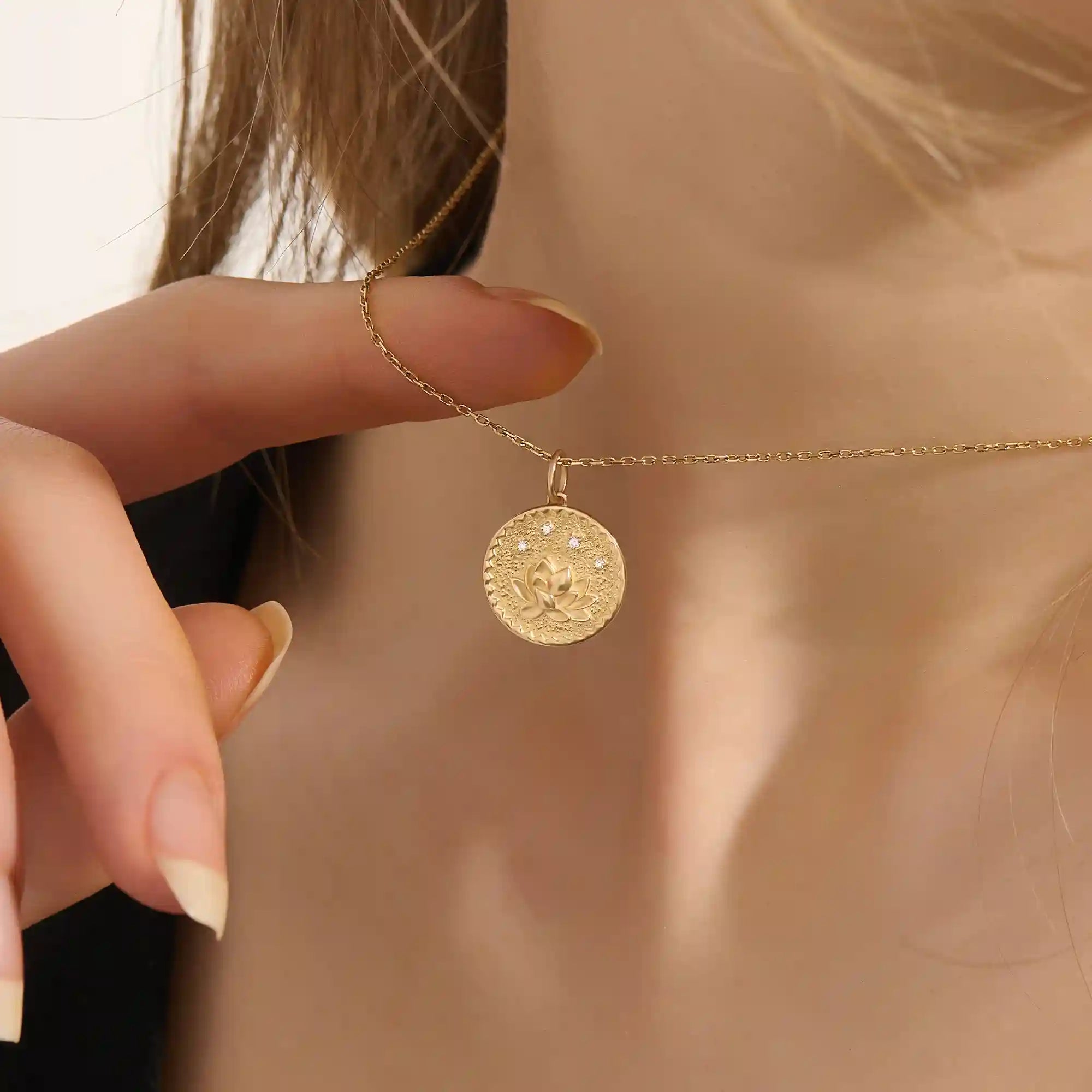 Woman wearing a 14k solid gold water lily pendant necklace with a delicate moissanite accent. Nature-inspired fine jewelry styled for everyday wear. Elegant and minimalist gold necklace for women.