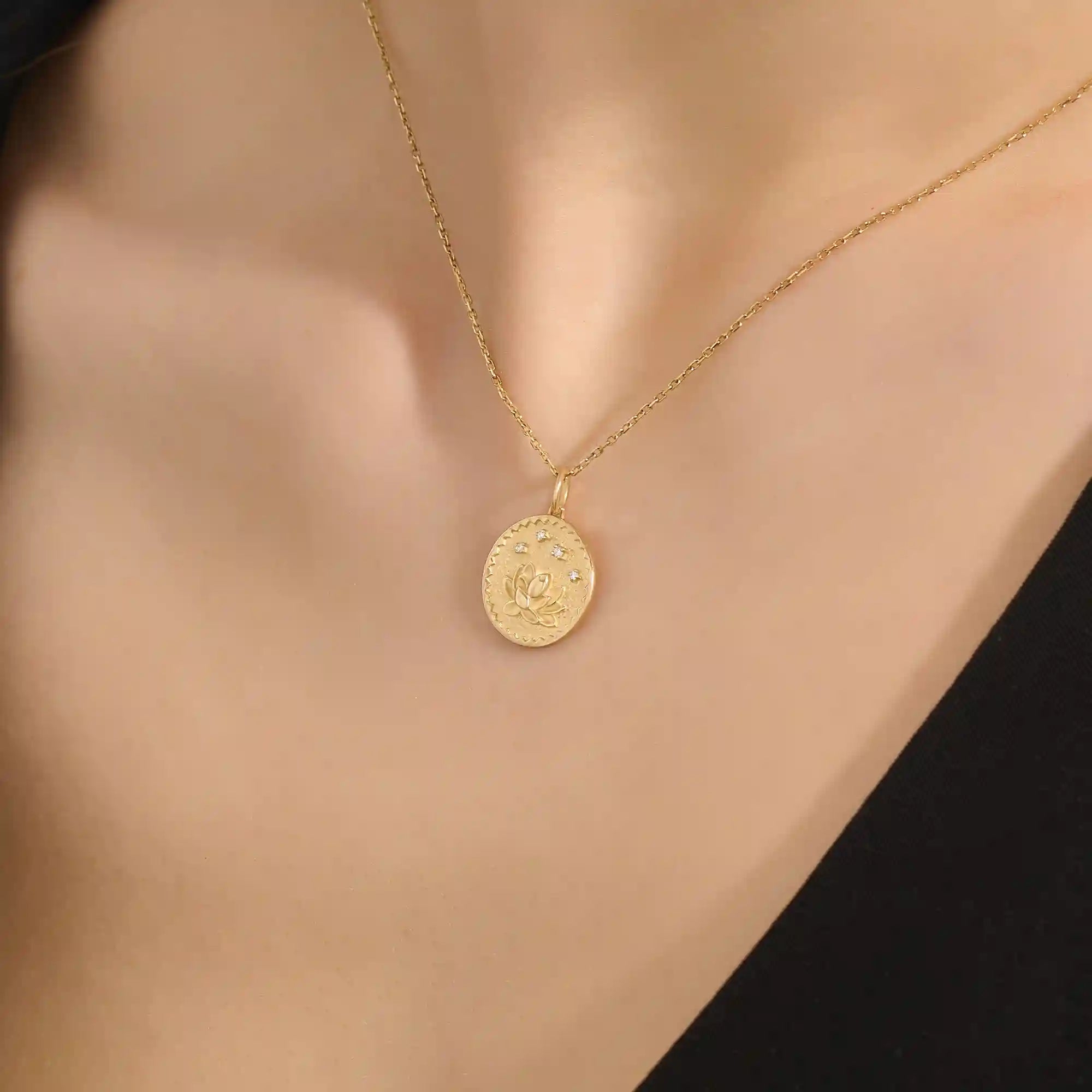 Woman wearing a 14k solid gold water lily pendant necklace with a delicate moissanite accent. Nature-inspired fine jewelry styled for everyday wear. Elegant and minimalist gold necklace for women.
