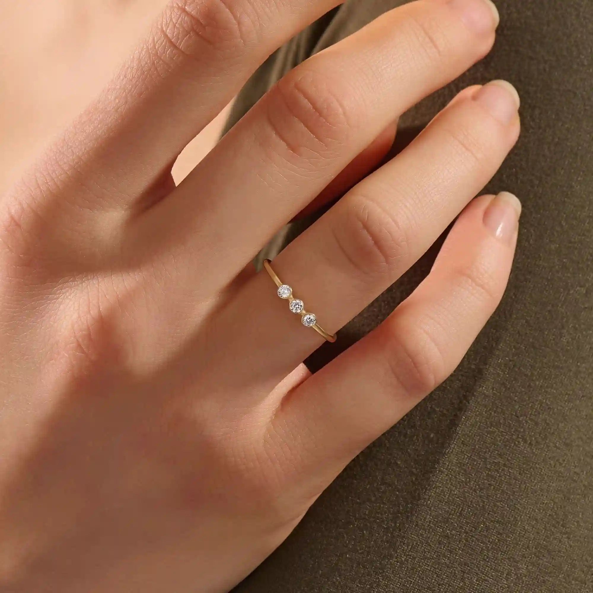 three bezel-set sparkling stones in brilliant 14k solid yellow gold slim band wedding stacking ring for women