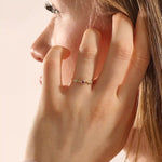 stacking wedding ring with a sparkling lab-grown ruby birthstone with moissanite stones each securely set in a bezel in 14k solid gold for women