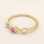 stacking wedding ring with a sparkling lab-grown ruby birthstone with moissanite stones each securely set in a bezel in 14k solid gold for women