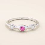 stacking wedding ring with a sparkling lab-grown ruby birthstone with moissanite stones each securely set in a bezel in 14k solid gold for women