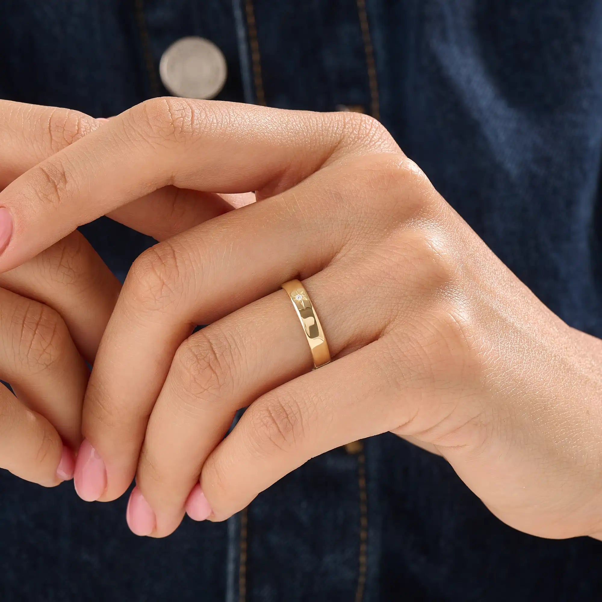 Model wearing a 14k gold vermeil Northstar ring with a cubic zirconia center stone and starburst detailing, minimalist celestial ring for women.
