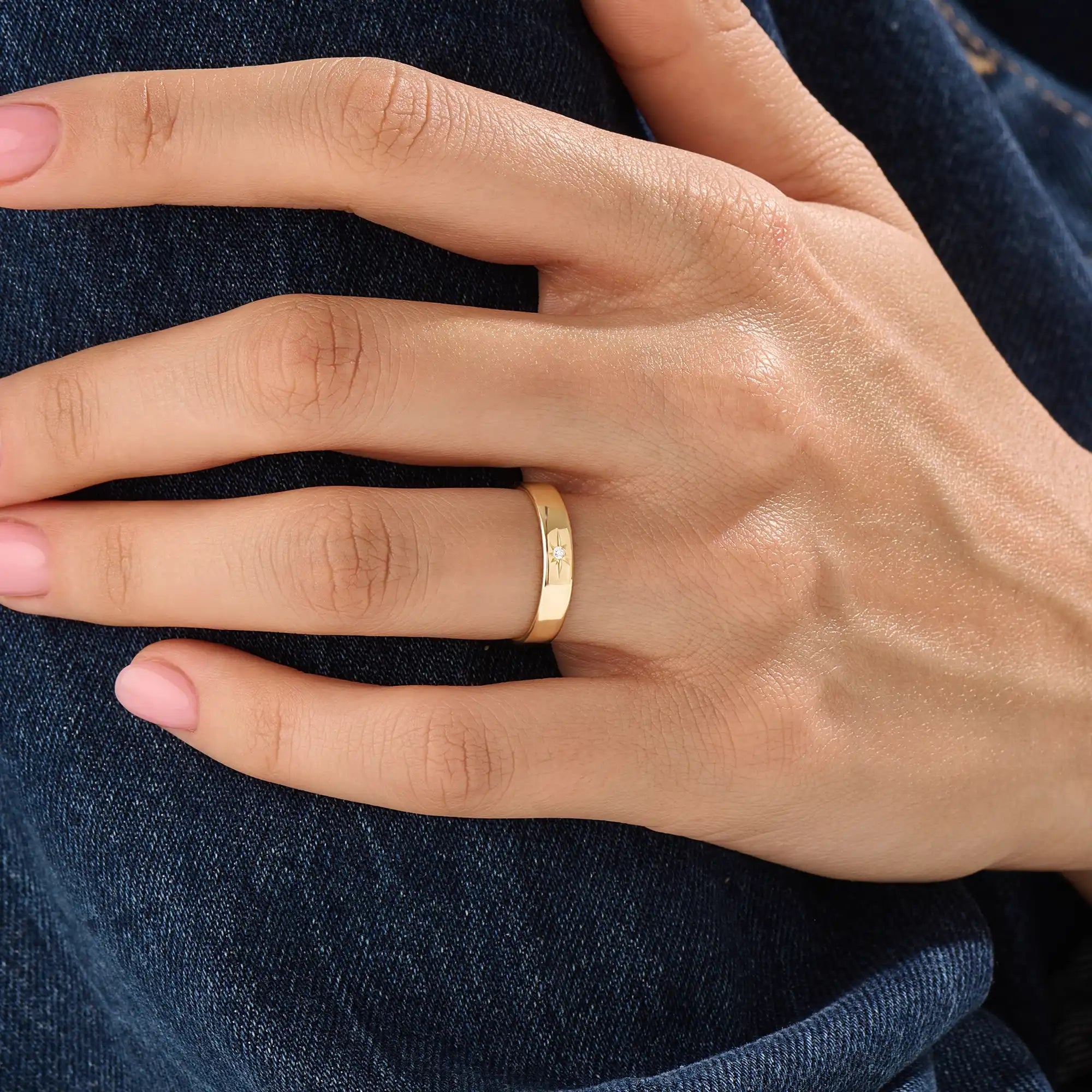 Model wearing a 14k gold vermeil Northstar ring with a cubic zirconia center stone and starburst detailing, minimalist celestial ring for women.
