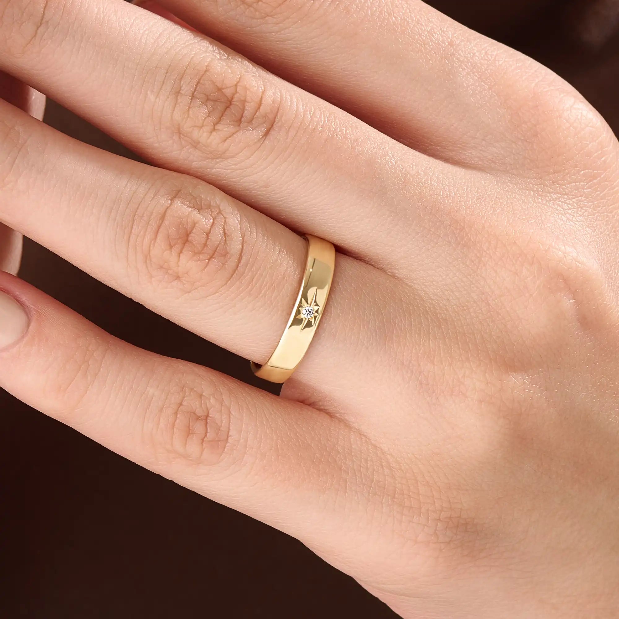 Model wearing a 14k gold vermeil Northstar ring with a cubic zirconia center stone and starburst detailing, minimalist celestial ring for women.
