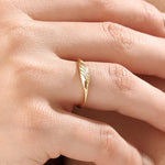 Model wearing a 14k gold vermeil small signet ring with a delicate twisted band design, elegant minimalist jewelry for women.
