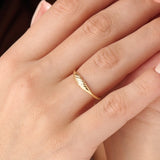 Model wearing a 14k gold vermeil small signet ring with a delicate twisted band design, elegant minimalist jewelry for women.
