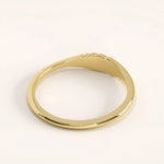 Side angle of 14k gold vermeil small signet ring showing the sculpted twisted detailing and refined craftsmanship.
