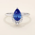 14k gold pear sapphire ring featuring white moissanite accents below the center stone. Elegant and timeless gemstone ring design.