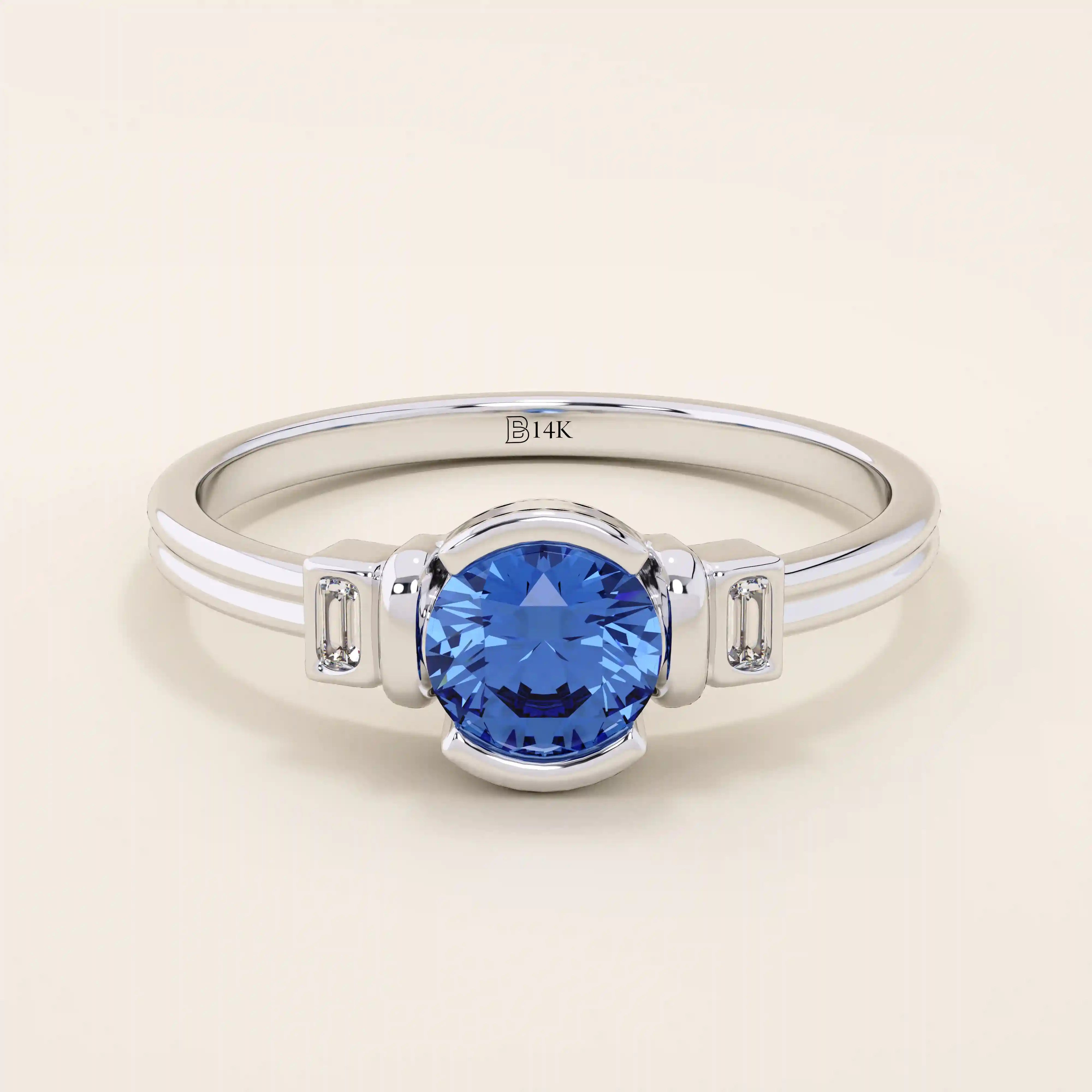 14k gold ring featuring a half bezel round sapphire with baguette moissanite accents. A modern gemstone anniversary band with elegant sparkle.