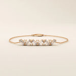 14k rose gold baguette bar bracelet showcasing baguette-cut stones paired with brilliant round stones on a delicate chain.
