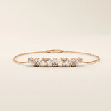 14k rose gold baguette bar bracelet showcasing baguette-cut stones paired with brilliant round stones on a delicate chain.
