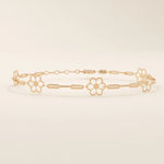 14k rose gold bracelet showcasing floral charms along a fine linked chain, adding a feminine touch.
