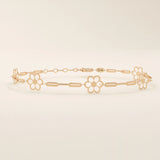 14k rose gold bracelet showcasing floral charms along a fine linked chain, adding a feminine touch.

