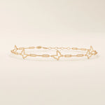 14k rose gold bracelet with airy butterfly cutout charms and slim chain details for a feminine design.
