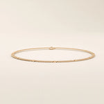 14k rose gold bracelet with curb-style chain links highlighted by round disc details.
