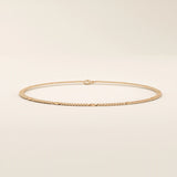 14k rose gold bracelet with curb-style chain links highlighted by round disc details.
