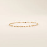 14k rose gold bracelet with delicate textured circle links in a shimmering starburst motif.
