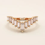 14k rose gold curved wedding ring featuring baguette moissanite stones, unique gold band enhancer for women’s engagement rings.
