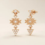 14k rose gold dangling motif stud earrings featuring geometric star and triangle elements set with moissanite stones.
