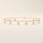 14k rose gold star bracelet with hanging star charms and small beaded accents for a playful, feminine style.
