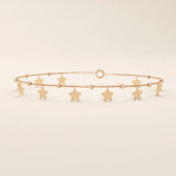 14k rose gold star bracelet with hanging star charms and small beaded accents for a playful, feminine style.
