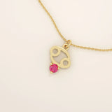 14k solid gold Cancer zodiac pendant necklace featuring a vibrant lab-grown ruby birthstone. A personalized and meaningful zodiac jewelry piece.