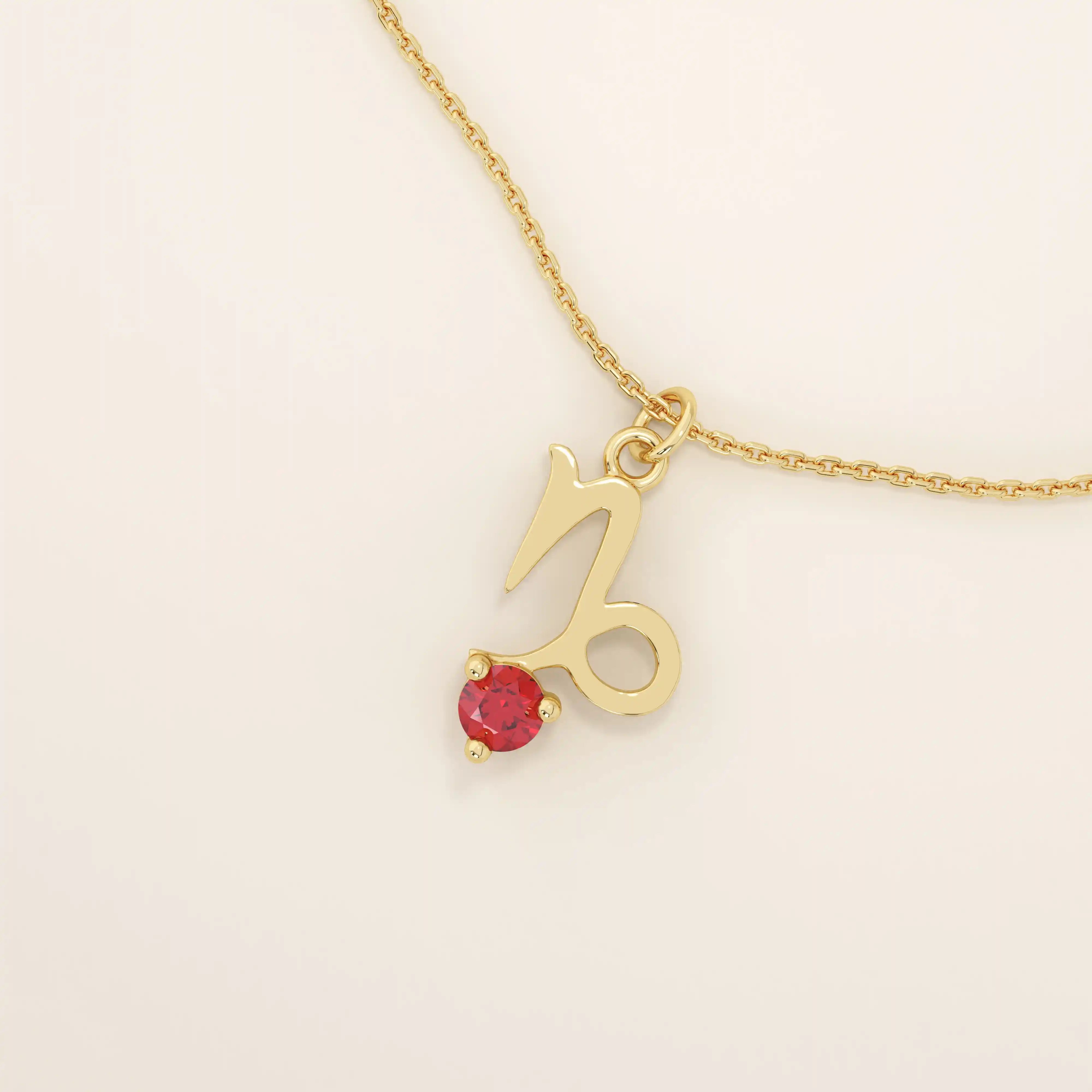 14k solid gold Capricorn symbol pendant necklace featuring a deep red garnet birthstone. A meaningful zodiac necklace perfect for personalized gifting.