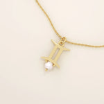 14k solid gold Gemini zodiac symbol pendant necklace with a natural pearl charm, minimalist celestial design.