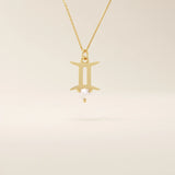 14k solid gold Gemini zodiac symbol pendant necklace with a natural pearl charm, minimalist celestial design.
