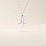 14k solid gold Gemini zodiac symbol pendant necklace with a natural pearl charm, minimalist celestial design.
