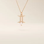 14k solid gold Gemini zodiac symbol pendant necklace with a natural pearl charm, minimalist celestial design.