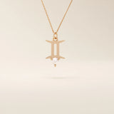 14k solid gold Gemini zodiac symbol pendant necklace with a natural pearl charm, minimalist celestial design.