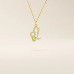 14k solid gold Leo zodiac symbol pendant necklace with a round green peridot, minimalist astrology birthstone jewelry.